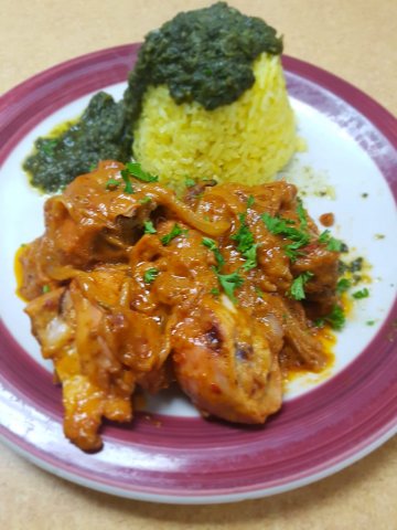 Yassa chicken with saffron rice and spinach sauce